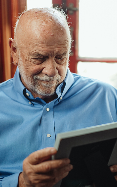man looking at photo album